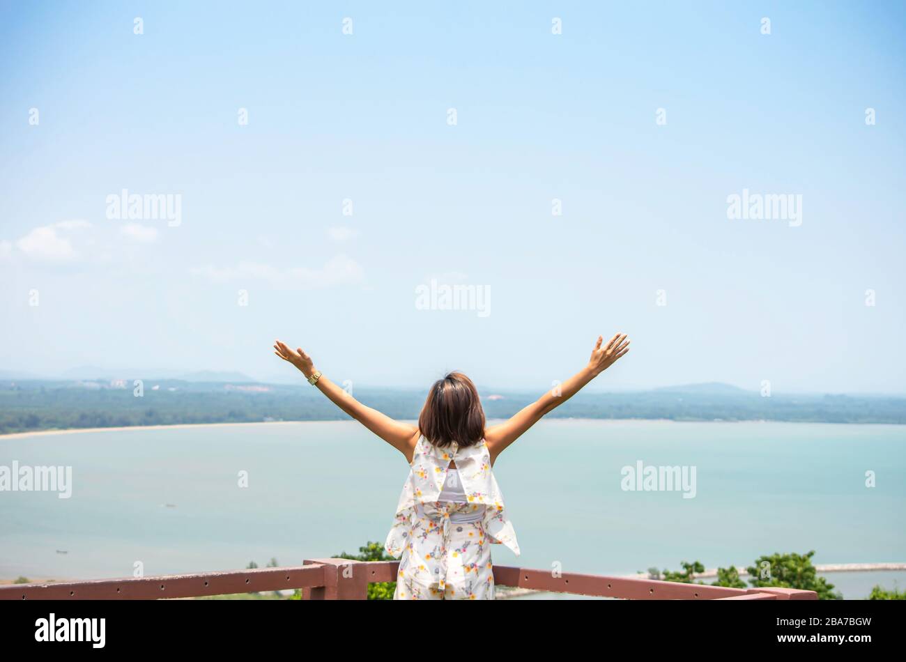 Women raise their arms background sea and sky Stock Photo - Alamy