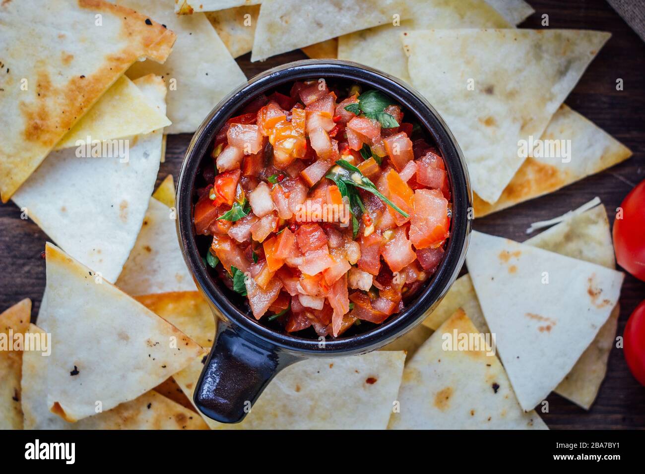 Hot mexican salsa spicy dip with nachos chips from corn Stock Photo