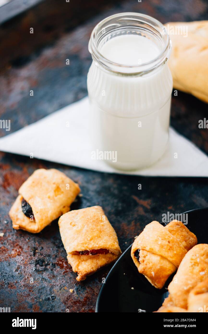 Nice breakfast - milk with croissants on black rustic surface Stock Photo
