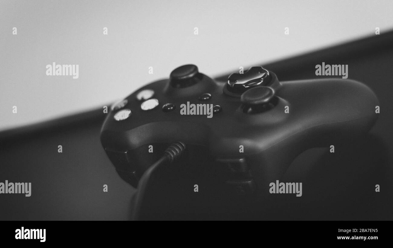High angle closeup shot of a black joystick on a black surface with a ...