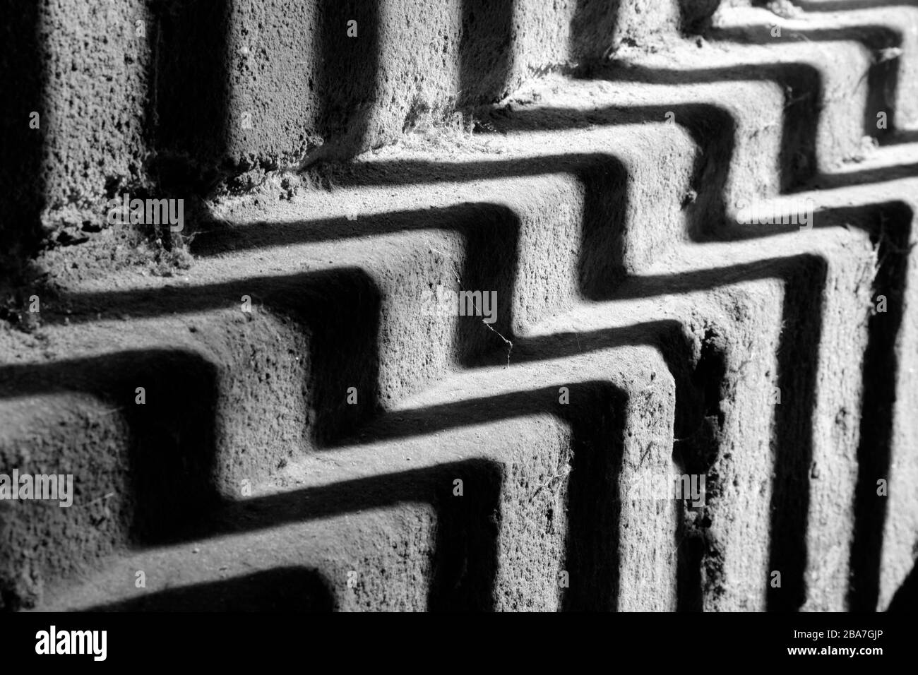 Sun and shadows play zigzag in the arch below the Serpentine Bridge, Kensington Gardens, London, UK Stock Photo