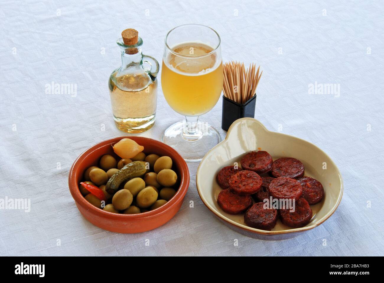 A selection of tapas with beer, Sliced Chorizo sausage and green olive cocktail, Costa del Sol, Malaga Province, Andalucia, Spain, Western Europe. Stock Photo