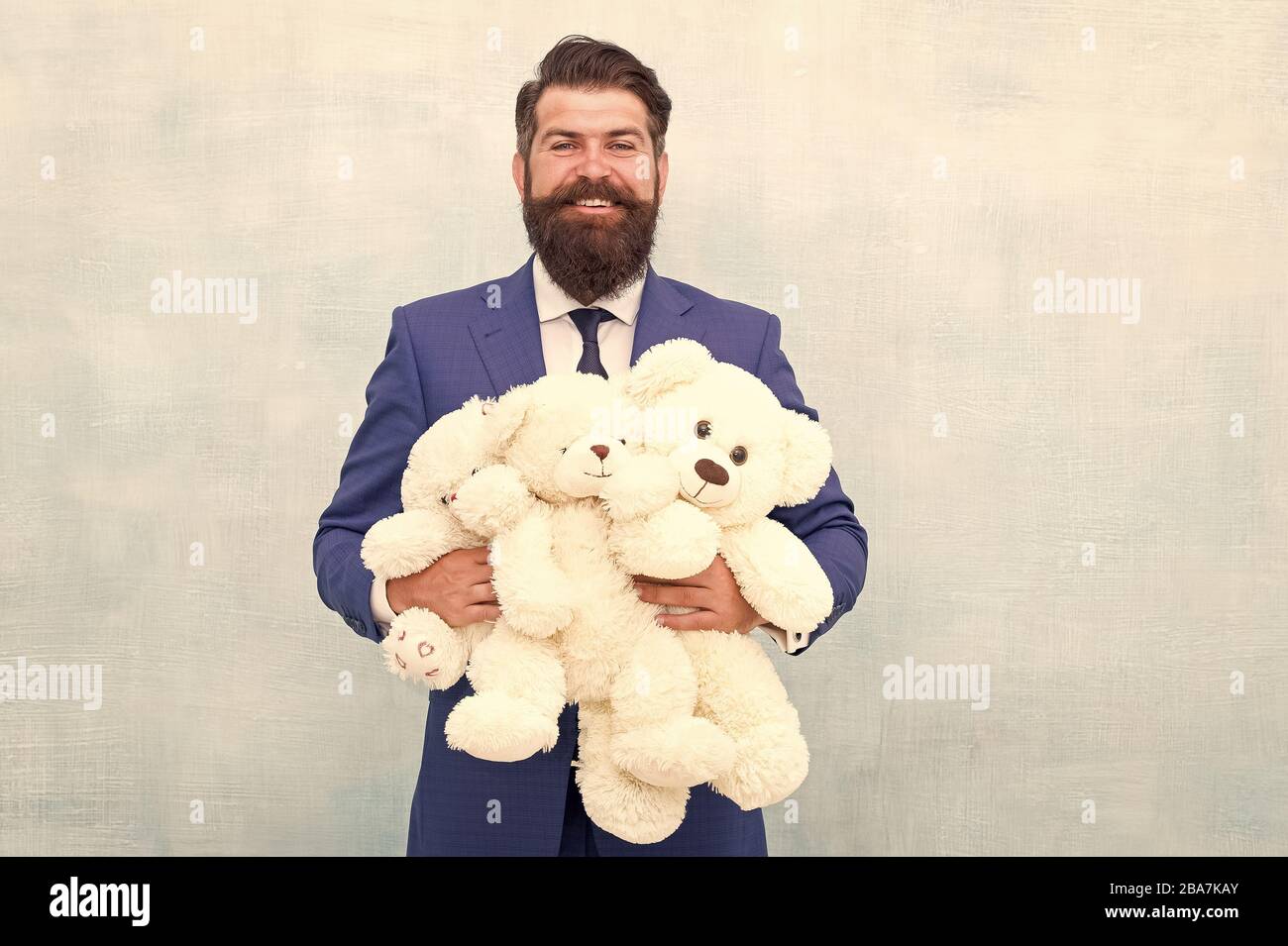 Lets play all day. Happy businessman play with soft toys. Childhood