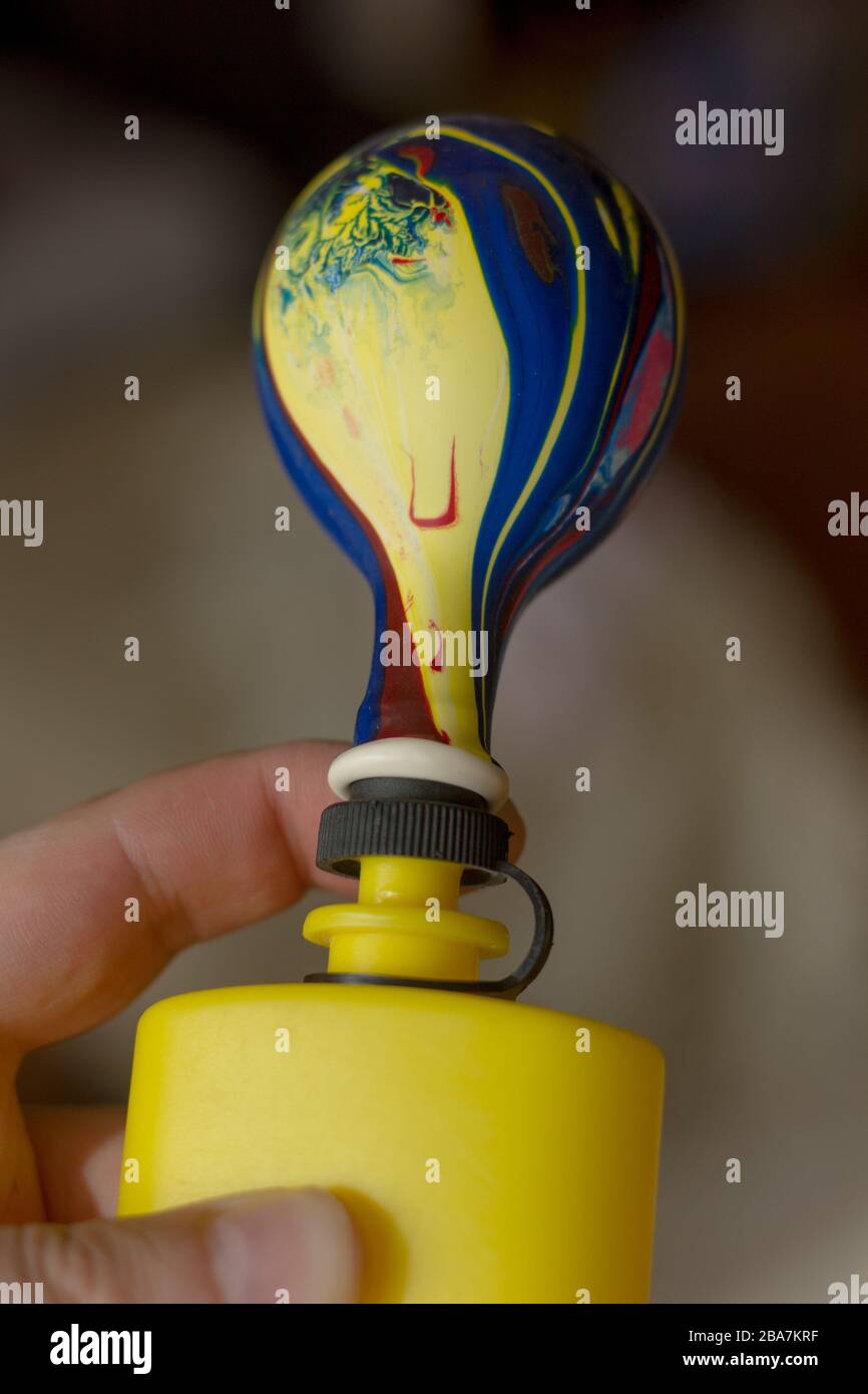 Blowing up balloon with the plastic pump Stock Photo Alamy