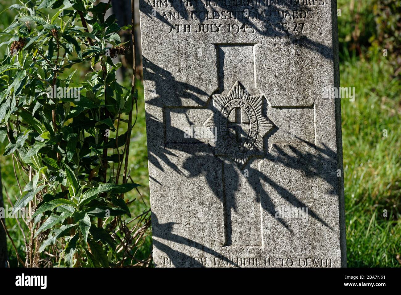 Shadow falling over a Saxon Cross imprinted in a gravestone. Stock Photo
