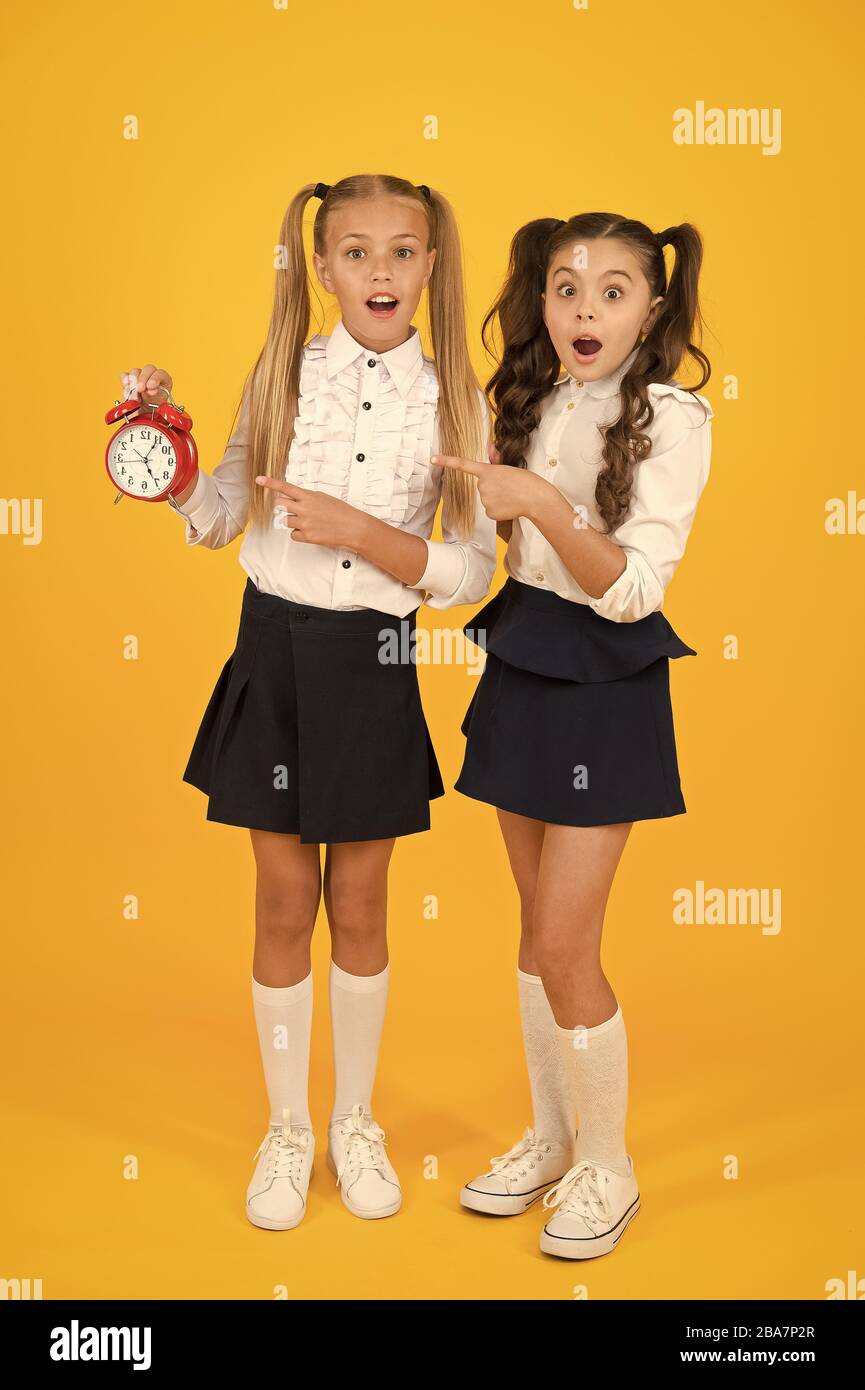 What is retro time. Surprised small children pointing at retro clock on