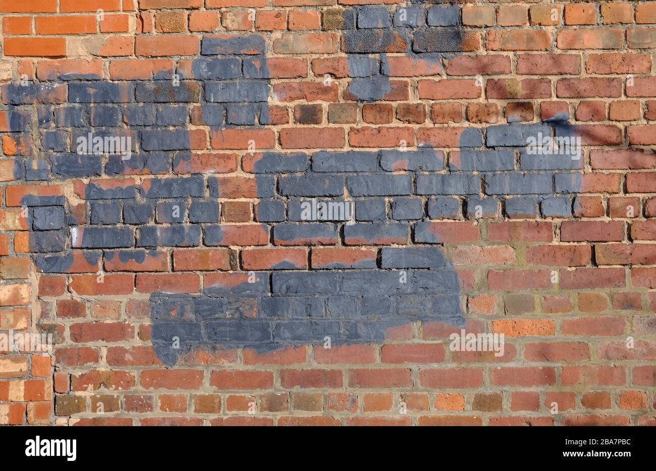 paintedover graffiti on a brick wall Stock Photo Alamy