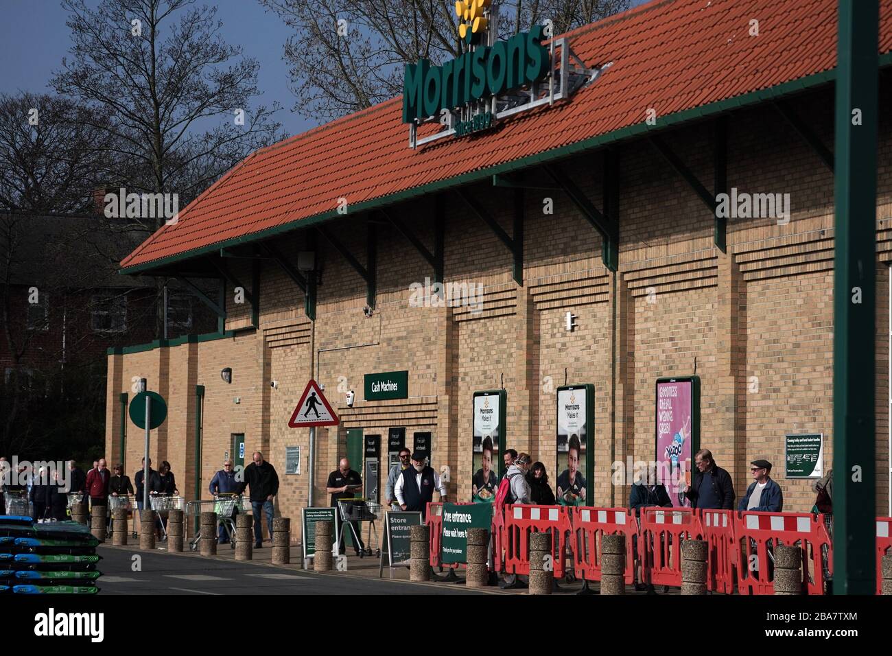 Customers social distancing in the queue outside Morrisons supermarket in Whitley Bay, Tyne and Wear, after Prime Minister Boris Johnson put the UK in lockdown to help curb the spread of the coronavirus. Stock Photo