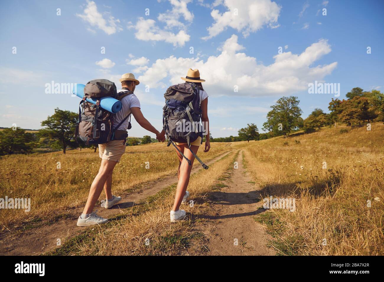 Hiking couple with backpack walking on hike in nature Stock Photo