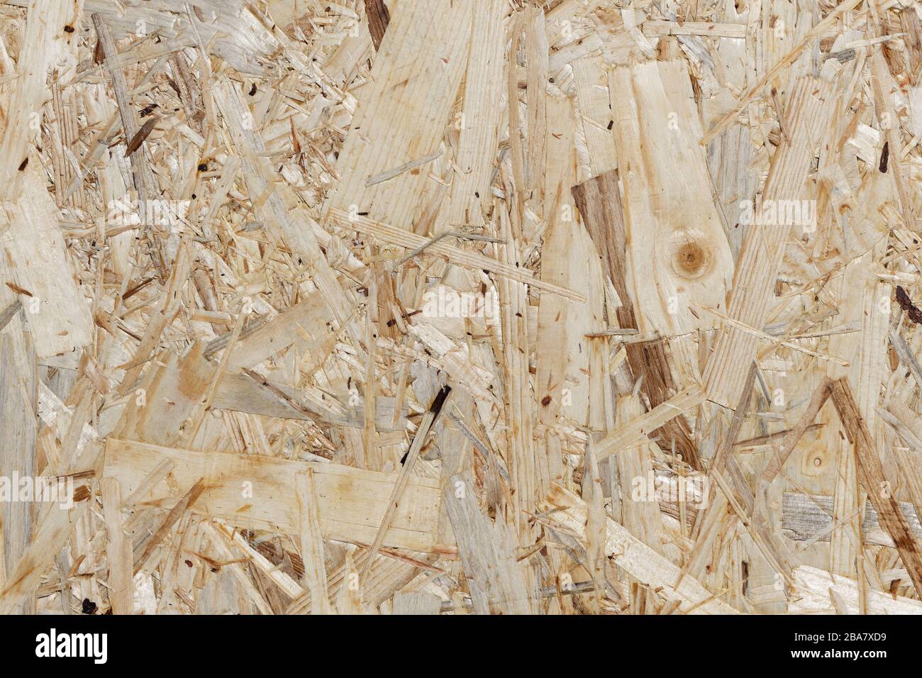Waste Wood Recycling Background of an Oriented Strand Board: section of an oriented strand board, made of different kinds of softwood strands Stock Photo