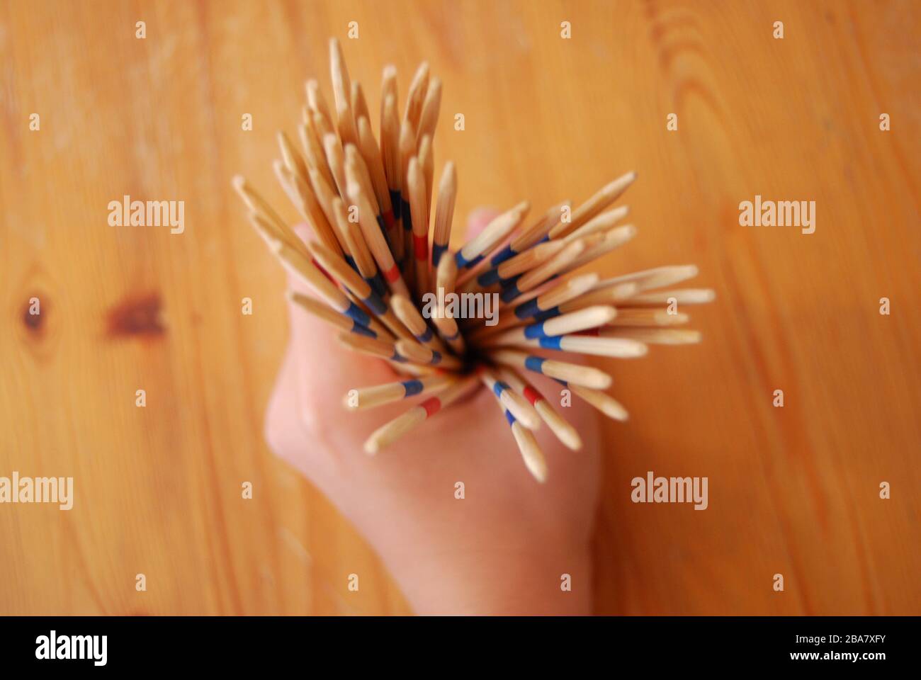 Wooden stick game in hands, playing toys - hobbies kids or adults Stock Photo