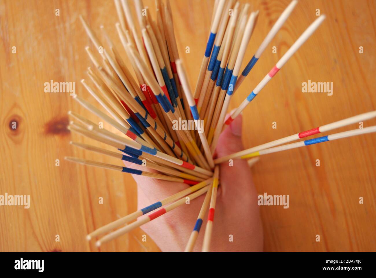 Wooden stick game in hands, playing toys - hobbies kids or adults Stock Photo