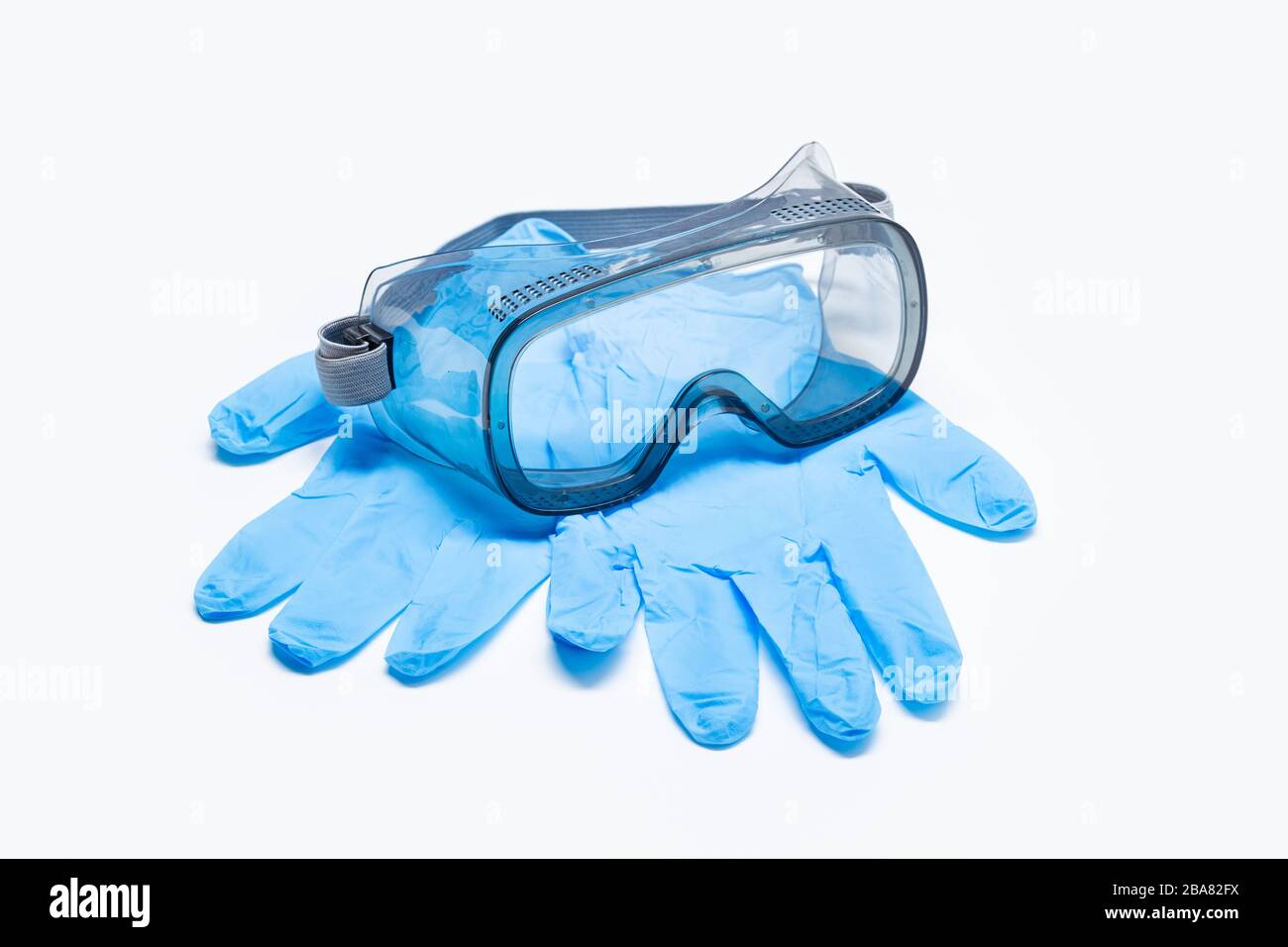 Safety equipment or Protective suit to fight to Coronavirus COVID-19 virus outbreak. Safety glasses and protective glove isolated on white background Stock Photo