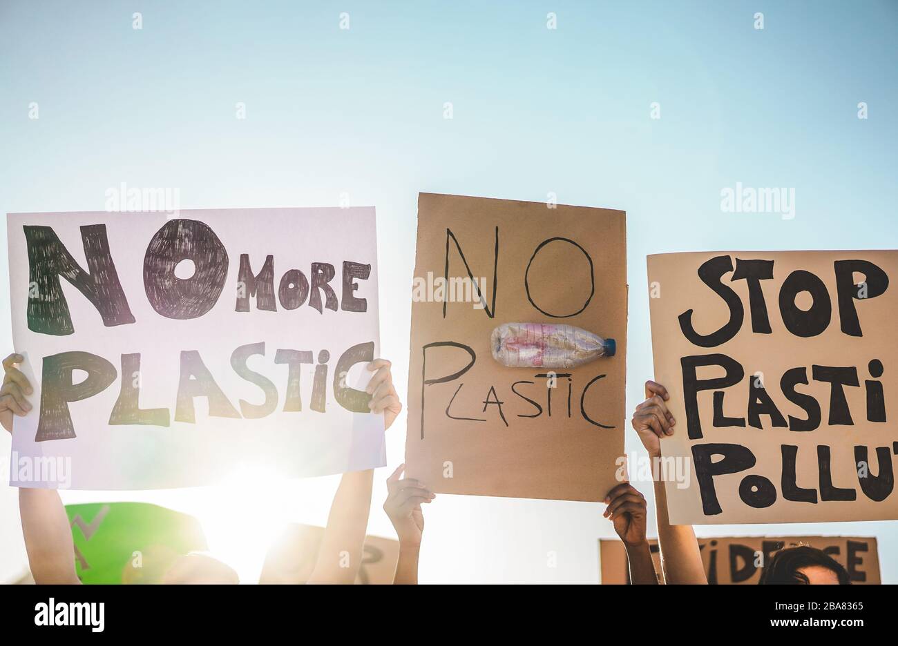 Group of millennials demonstrators on road, young people from different culture and races fight for plastic pollution and climate change - Global warm Stock Photo