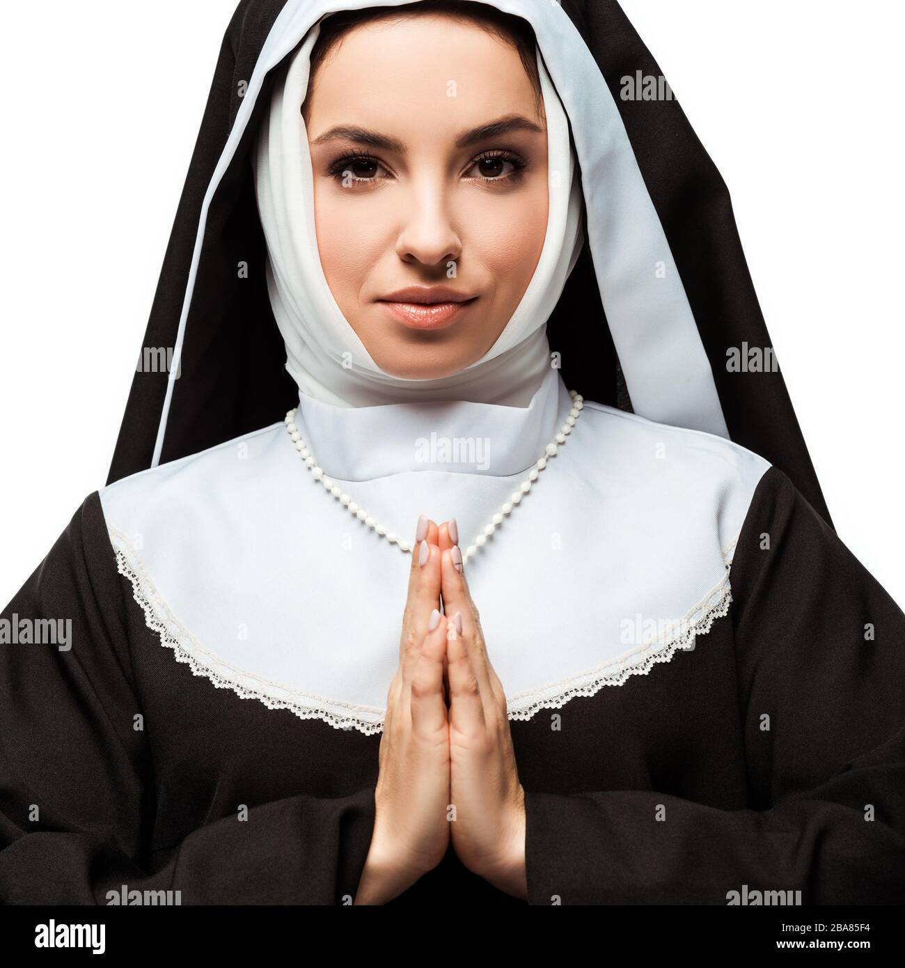 beautiful nun praying with hands together isolated on white Stock Photo