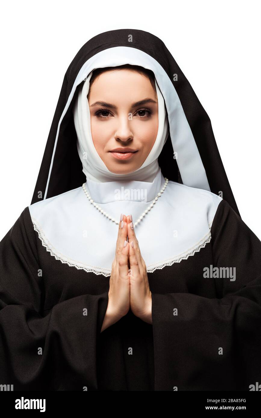 beautiful smiling nun praying with hands together isolated on white