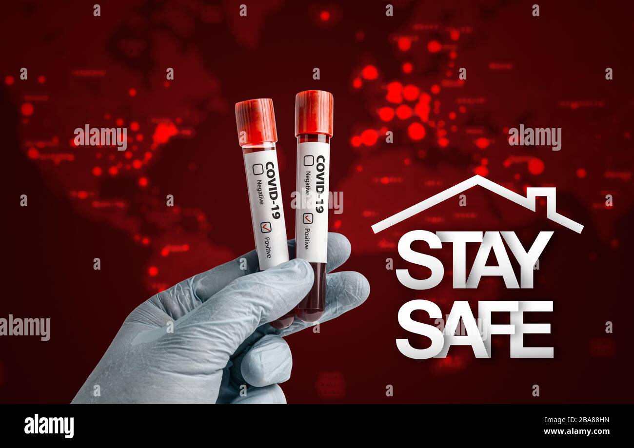 Pandemic COVID-19 concept: Scientist holding blood sample in test tubes with positive result.  Stay safe message over blurred America and Africa conti Stock Photo
