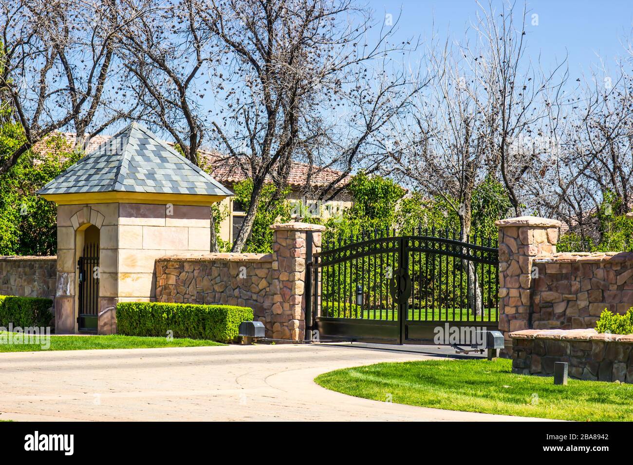 Electric Gate, Gate House And Flagstone Wall Stock Photo