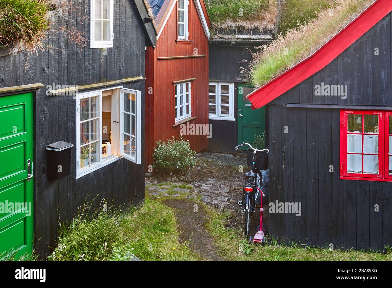 Traditional Faroe wooden black houses with grass turf roof. Picturesque Stock Photo