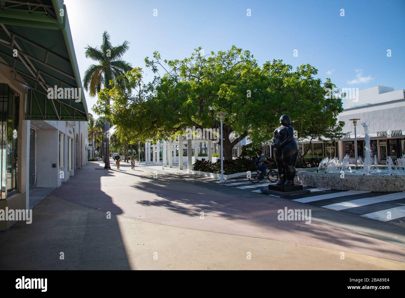 Miami Beach, Florida, USA - 2020/03/23: Virtually empty Lincoln road after closing Business, restaurants and beaches. Bikers take the street for leisu Stock Photo