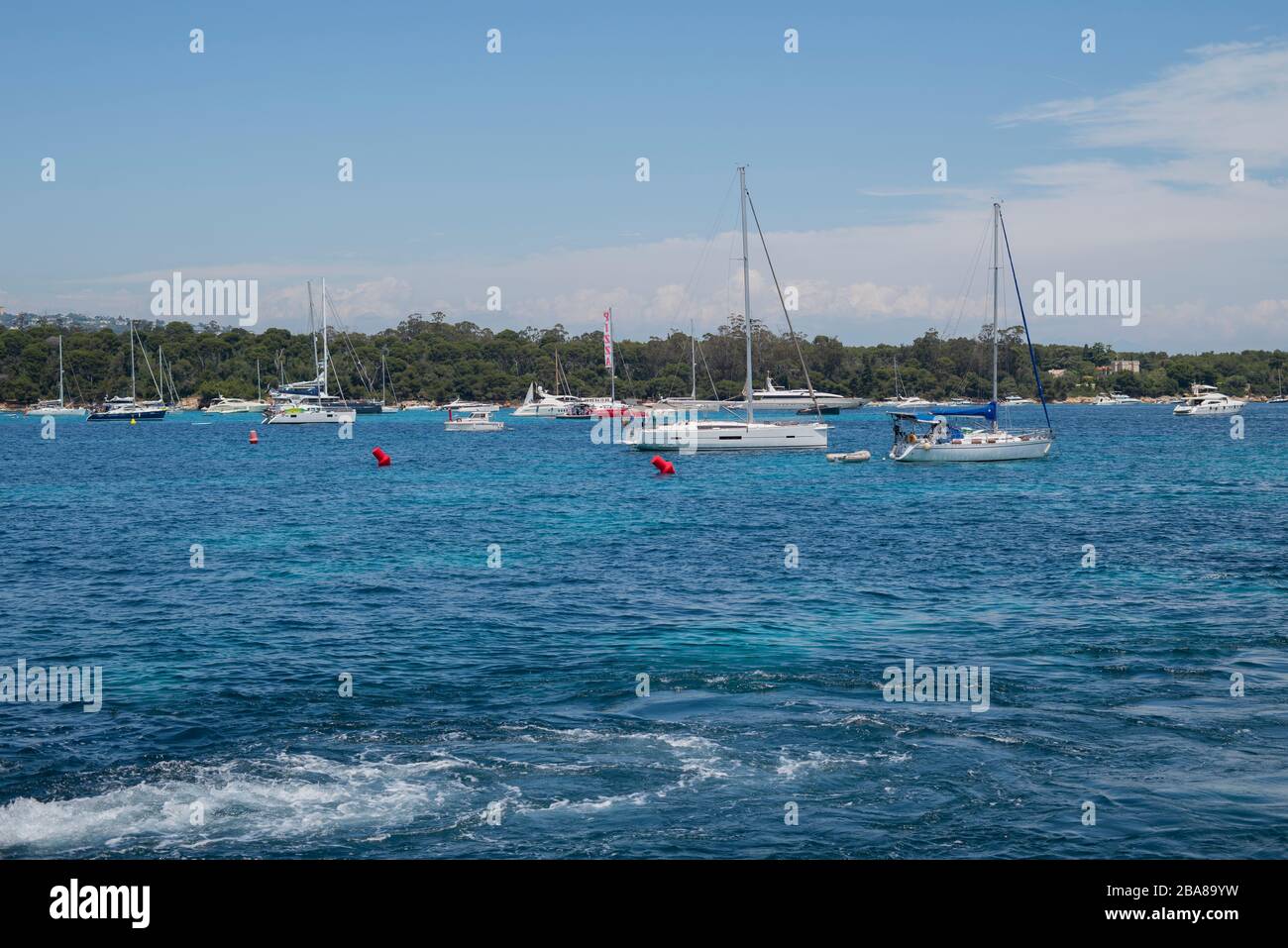 Beautiful view from Lerins Island. Saint Honore island. Yachts anchored in the blue bay of