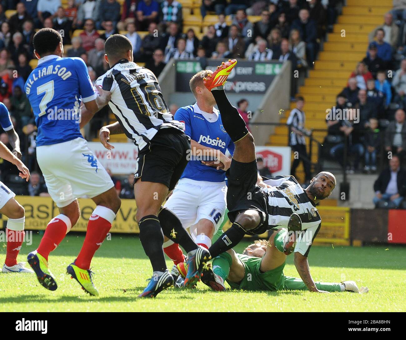 Notts County's Yoann Arquin clashes with Portsmouth's goalkeeper Mikkel Andersen as he scores their first goal Stock Photo