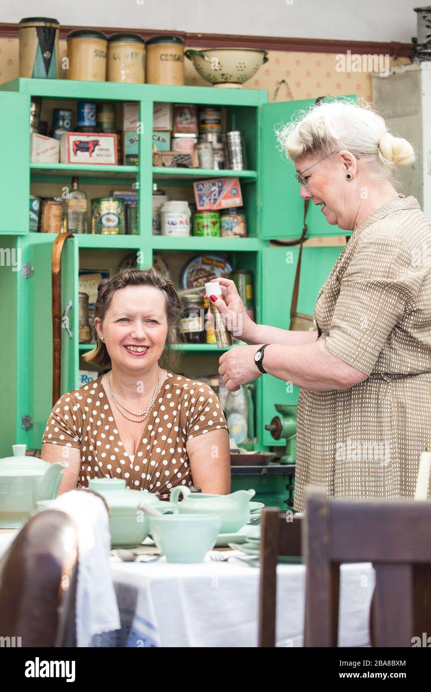 As the UK continues its enforced lockdown, home hairdressing seems to be the order of the day! Folk of the 1940s were all too familiar with the concepts of 'do it yourself' and 'making do' as these re-enactors show to visitors at a 'Step back to the 1940s' event. Hairdressing at home was just one of many newly-enjoyed skills developed by a wartime population struggling to get by in a challenging & difficult time of national crisis. Credit: Lee Hudson Stock Photo