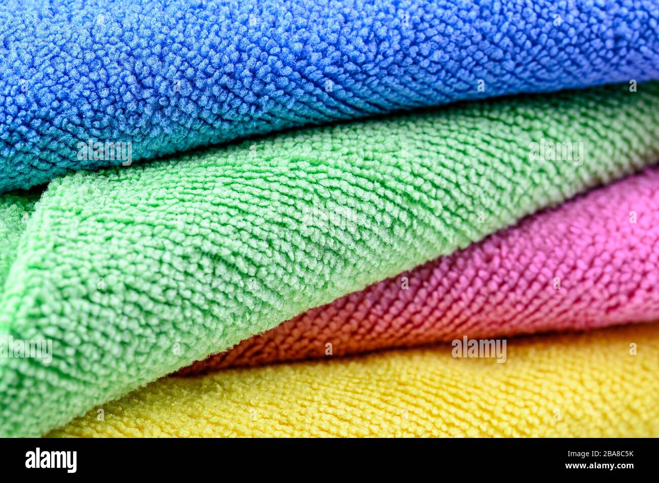 colorful microfiber towels for beach use and domestic cleaning stacked in a pile Stock Photo