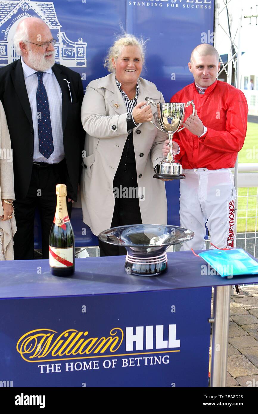 Jockey Tony Hamilton with a trophy after winning the Shadwell Stud Harry Rosebery Stakes on Garswood Stock Photo