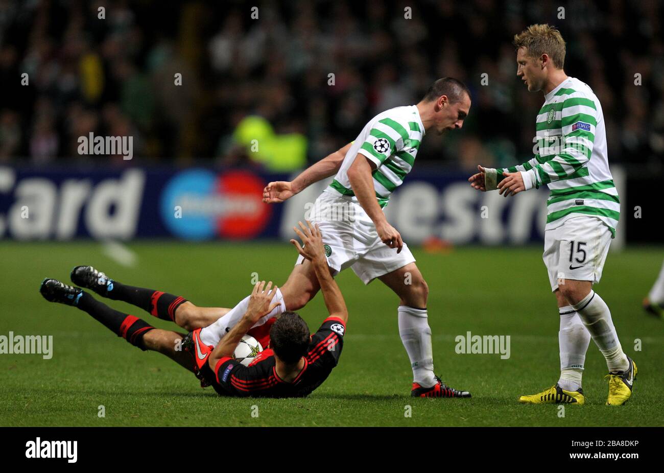 Celtic's Scott Brown leaves his foot in after challenging Benfica's Nemanja Matic to earn a yellow card Stock Photo