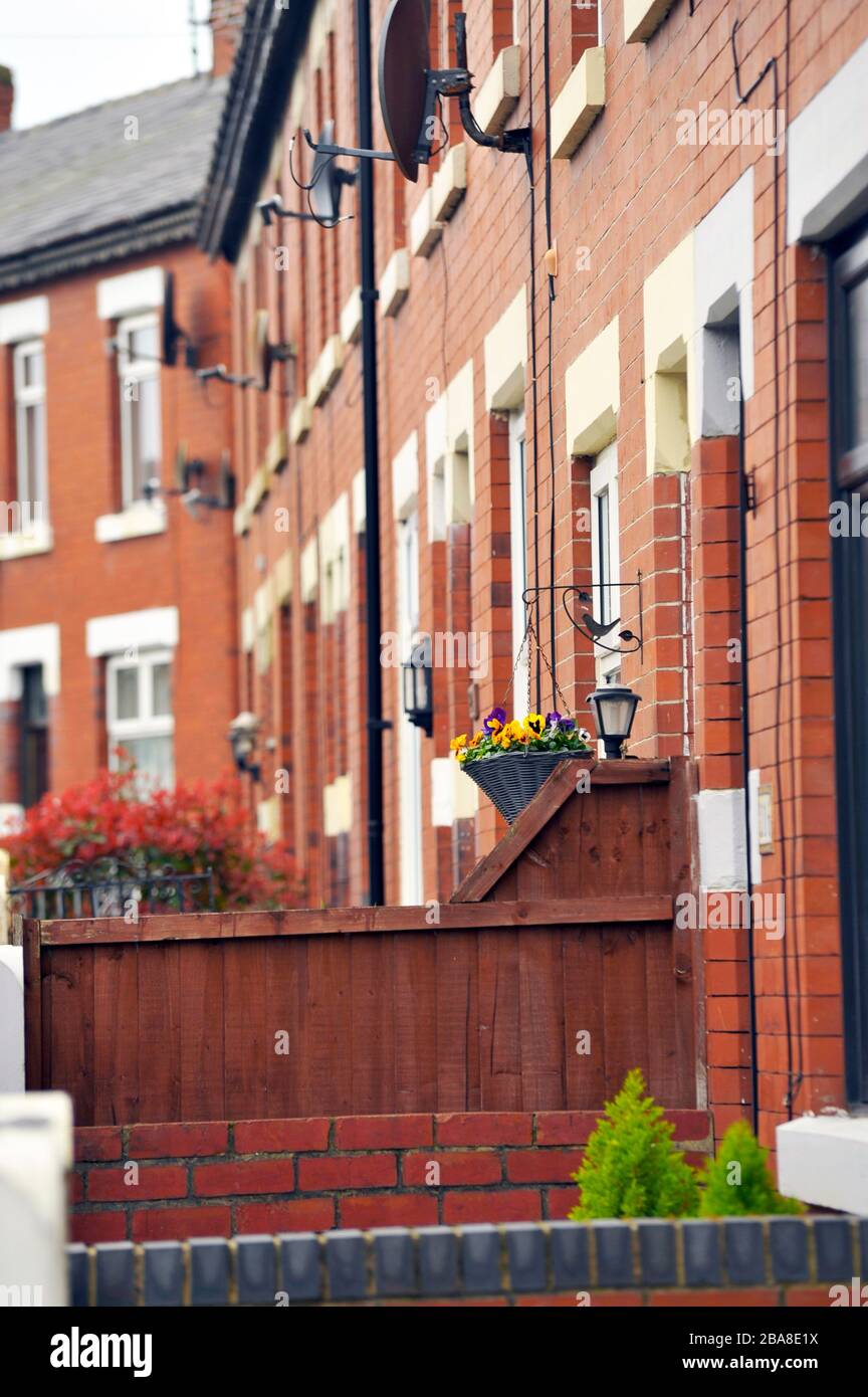 Row of red brick terrace houses with small front gardens Stock Photo