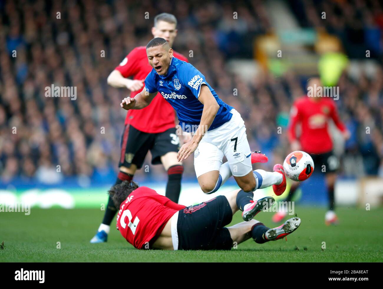 Everton's Richarlison (top) and Manchester United's Victor Lindelof collide Stock Photo