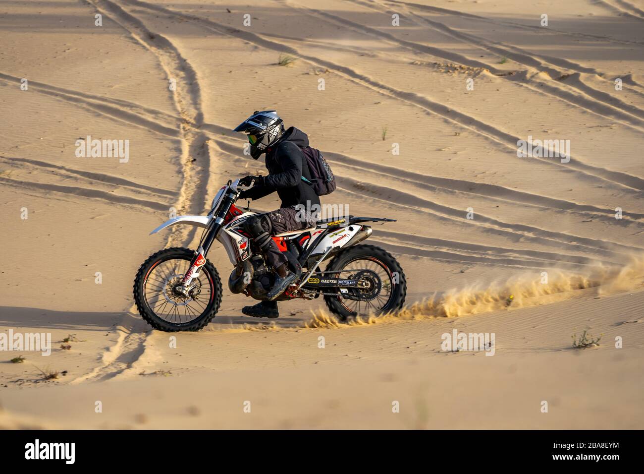 Dirt bike on a sand dune Stock Photo - Alamy