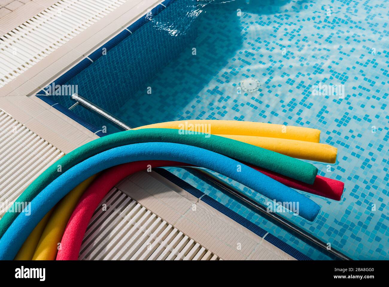 top view of colorful pool noodles near swimming pool Stock Photo Alamy