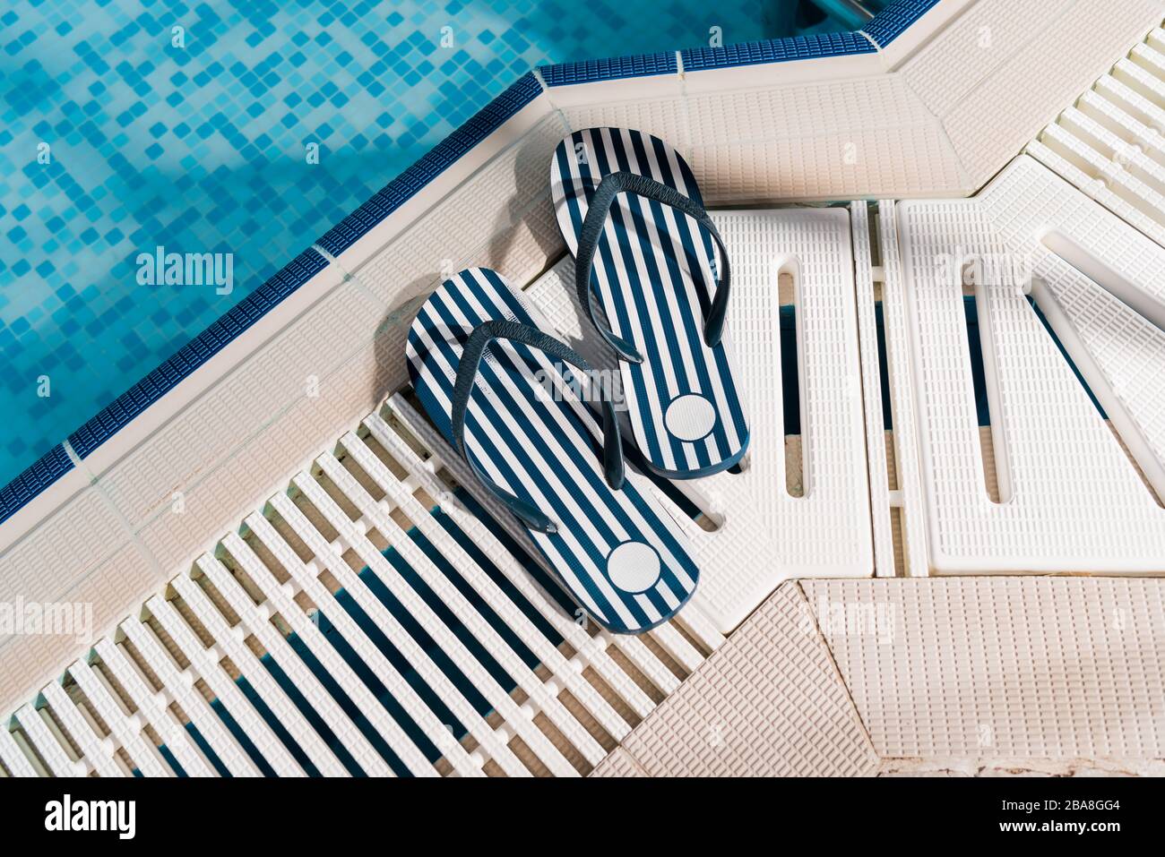 top view of flip flops near swimming pool with blue water Stock Photo ...