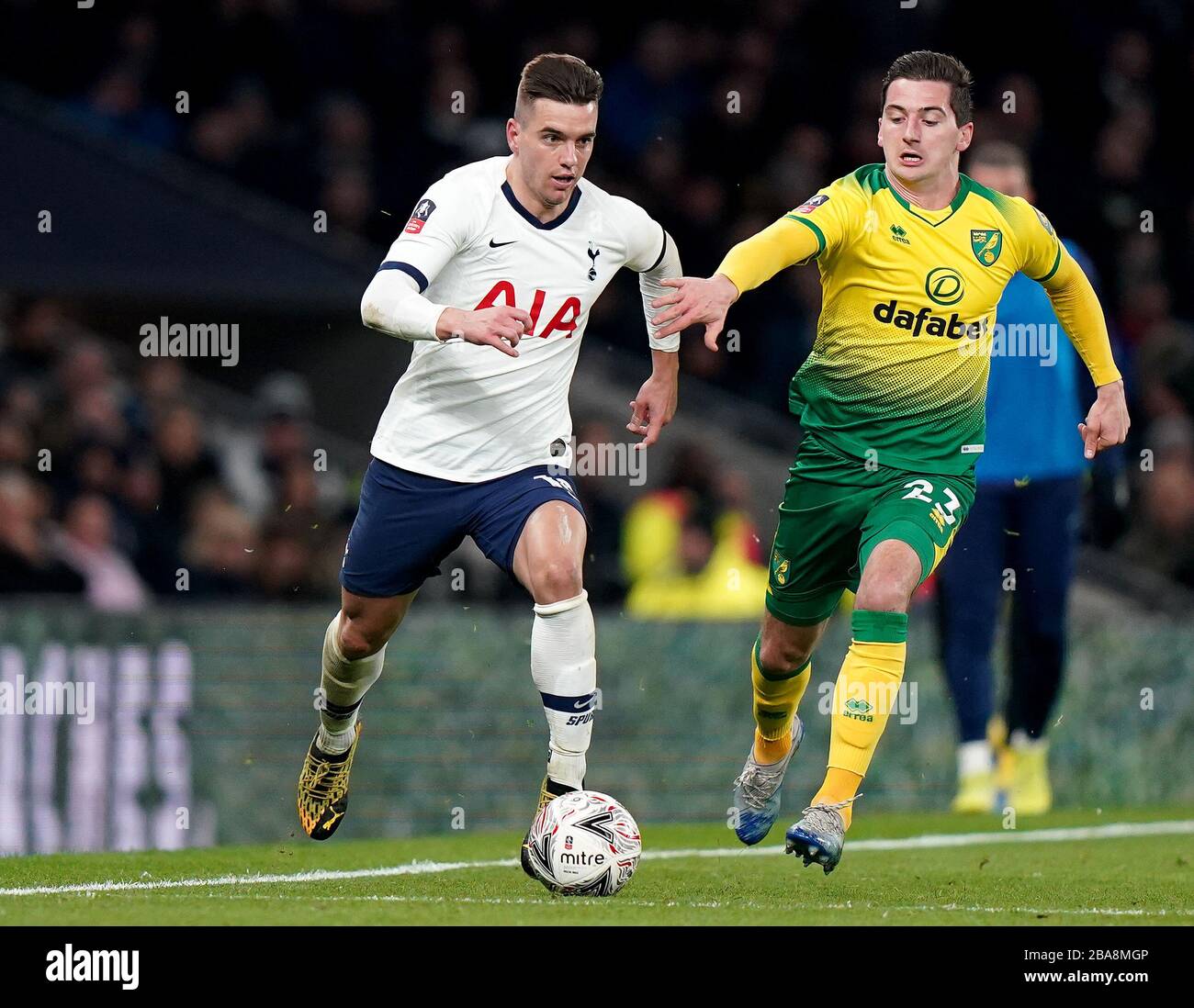 Tottenham Hotspurs Giovani Lo Celso (left) and Norwich Citys Kenny McLean battle for the ball Stock Photo
