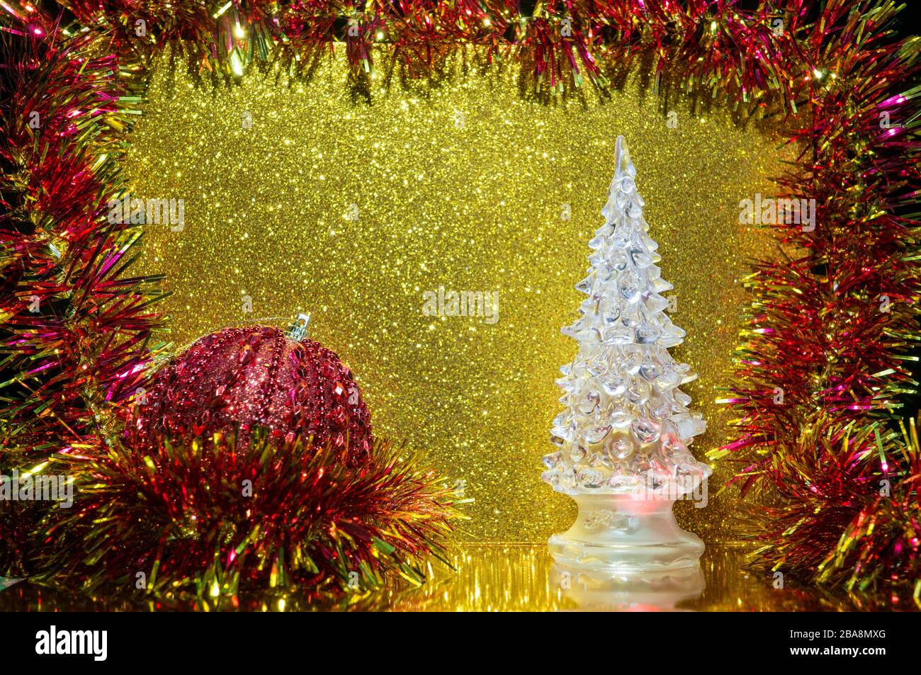 Bright colorful Christmas composition with a transparent artificial spruce and Christmas tree toy. Place for text. Greeting card Stock Photo