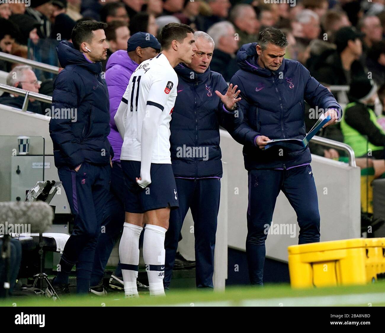 Tottenham Hotspur manager Jose Mourinho discusses tactics on the touchline with Erik Lamela Stock Photo