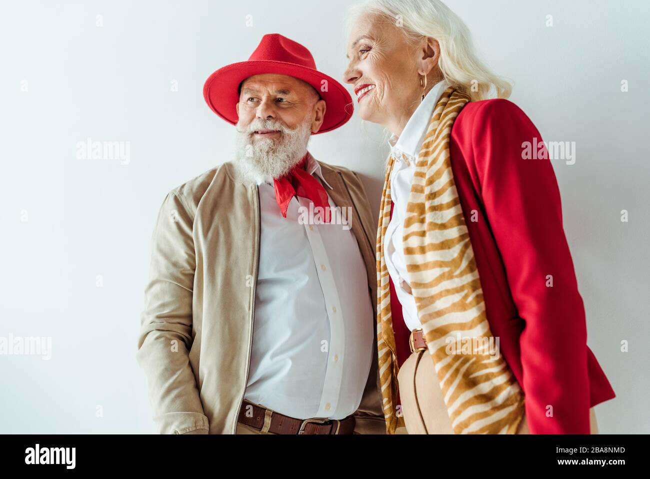 Stylish senior couple smiling away on white background Stock Photo - Alamy