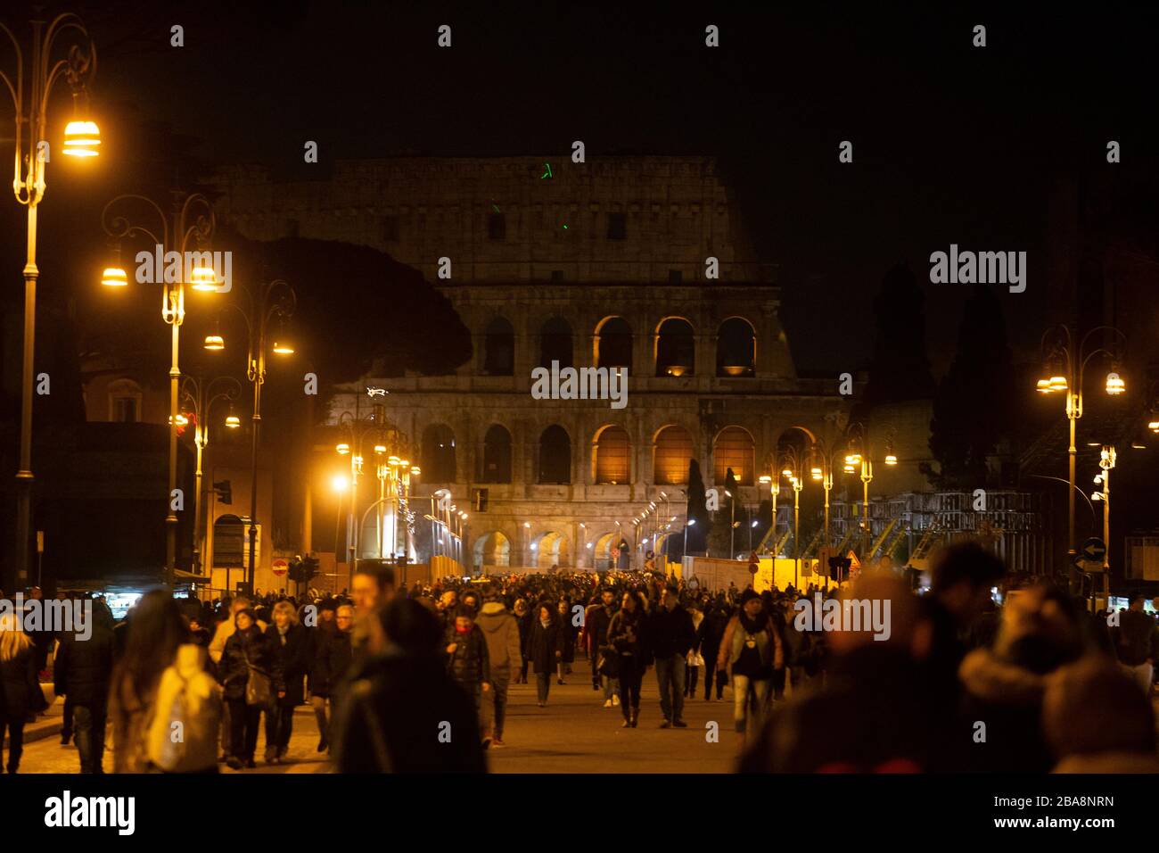 Tourists at the Colosseum in Rome at night Stock Photo