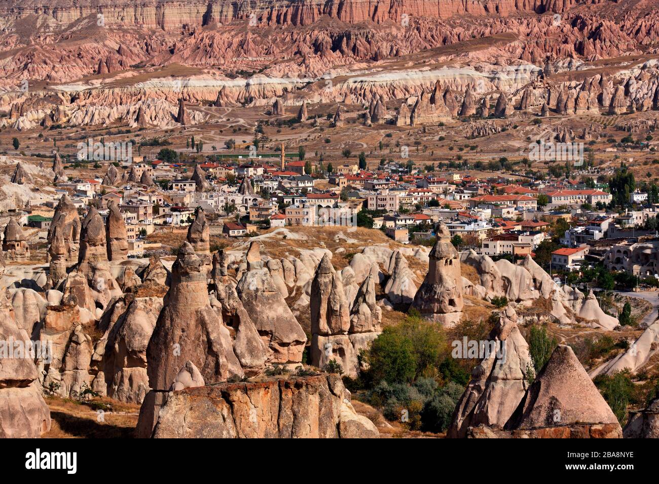 Partial view of picturesque Goreme village surrounded by the spectacular landscape of Cappadocia on the edge of Pigeon valley, Nevsehir, Turkey Stock Photo