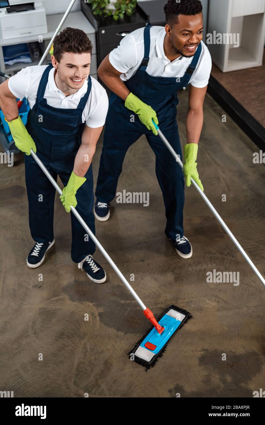 Two smiling multicultural cleaners hi-res stock photography and images ...