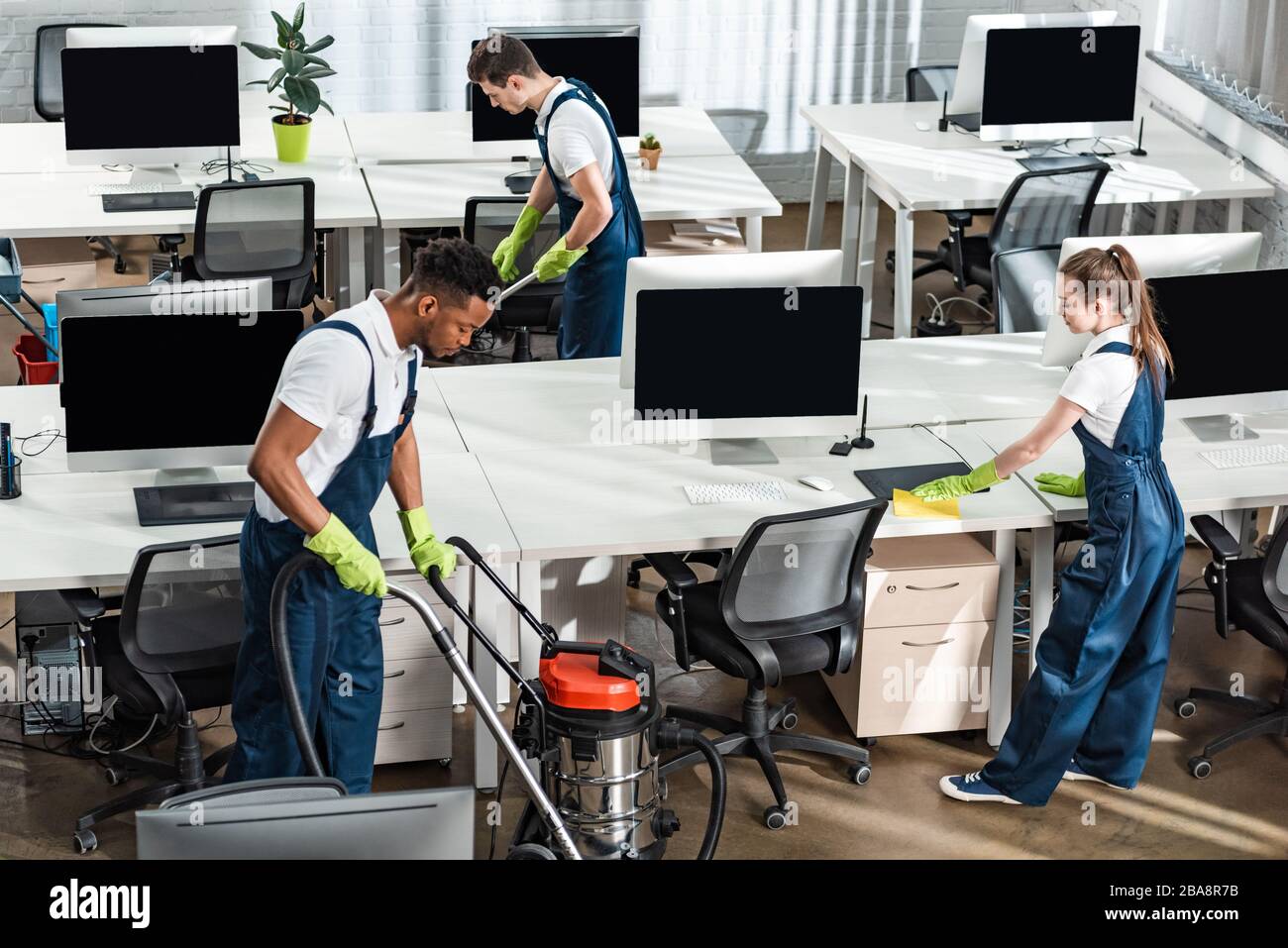 Cleaning office with vaccum cleaner hi-res stock photography and images ...