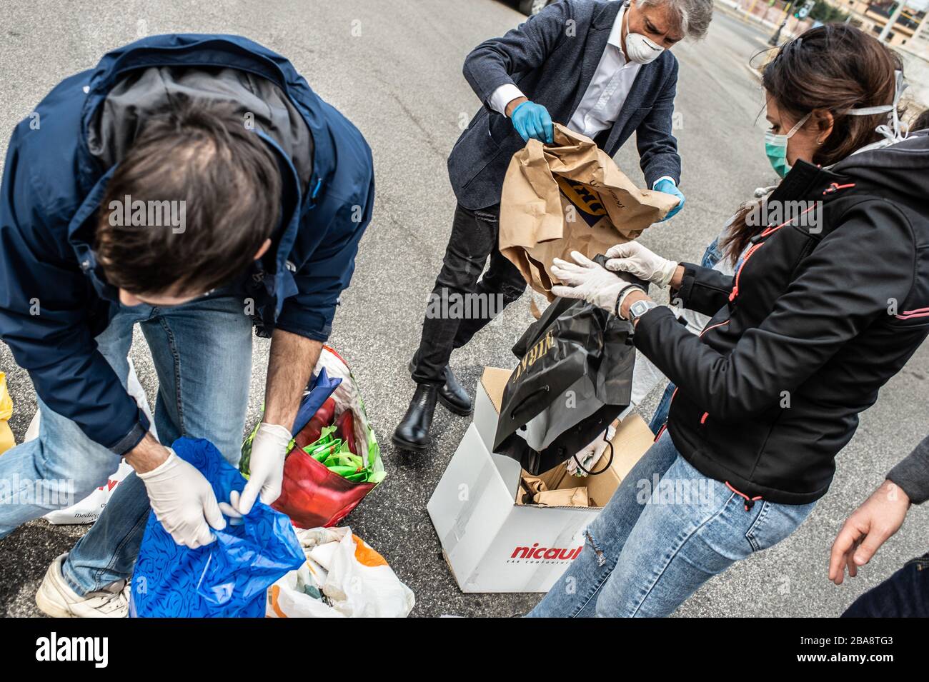 In Rome, during the terrible Coronavirus epidemic that hit Italy, the volunteers of the Community of Sant'Egidio distribute meals and health services to homeless people and other disadvantaged people who live on the streets. Stock Photo