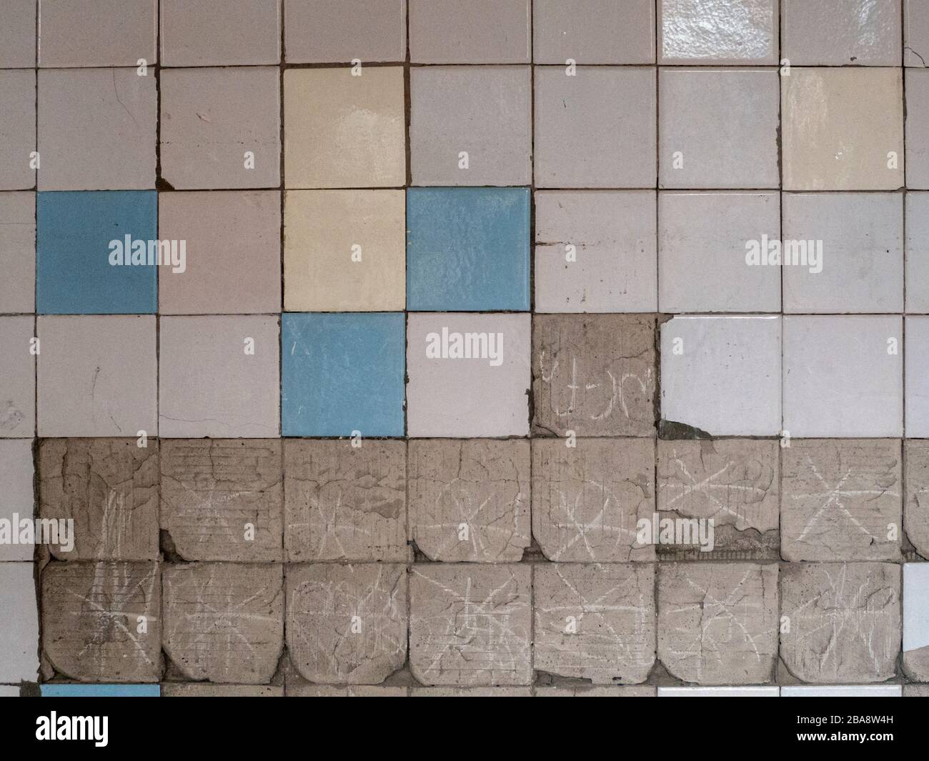 Old tiles and textures on decaying house wall Stock Photo