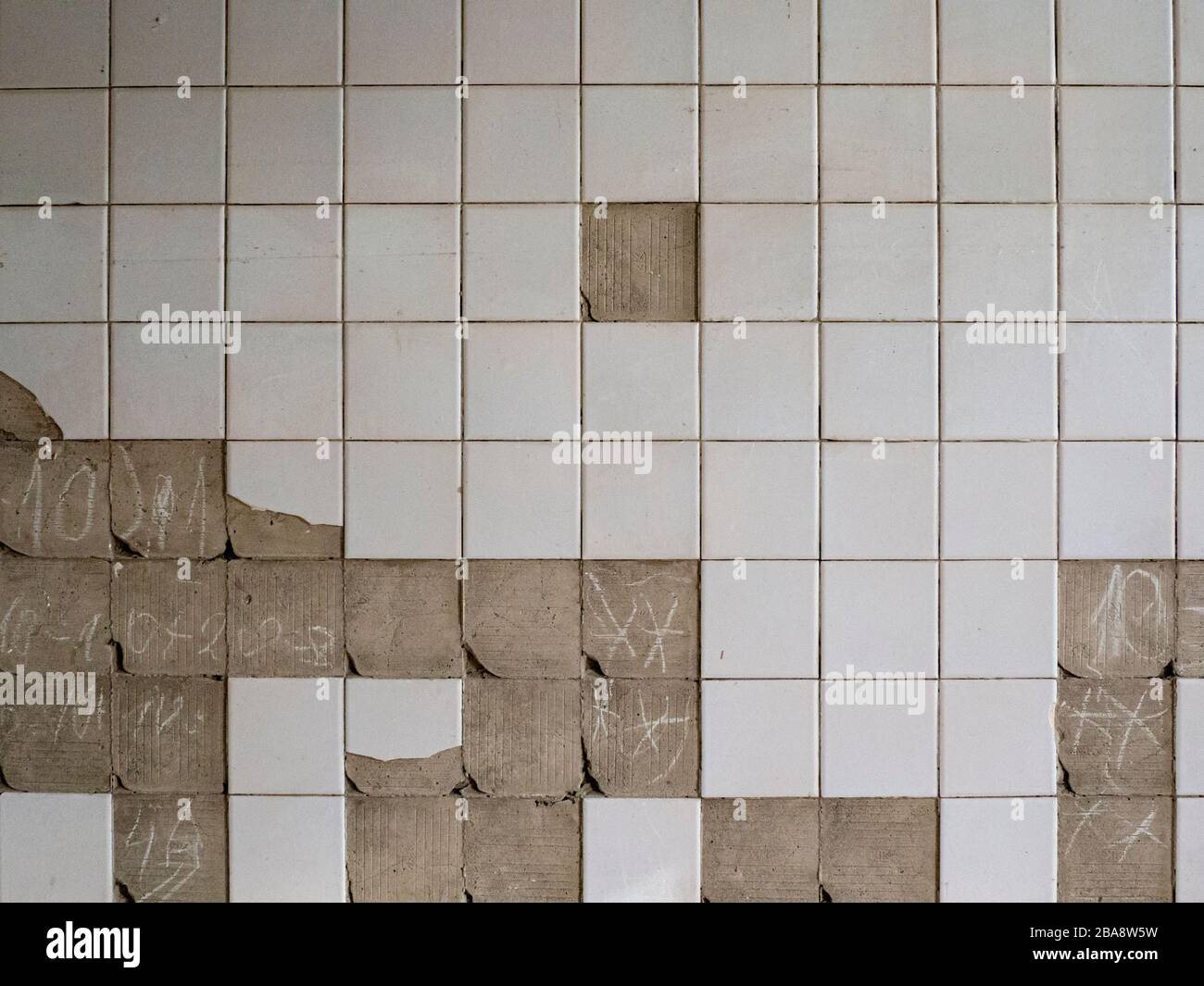 Old tiles and textures on decaying house wall Stock Photo