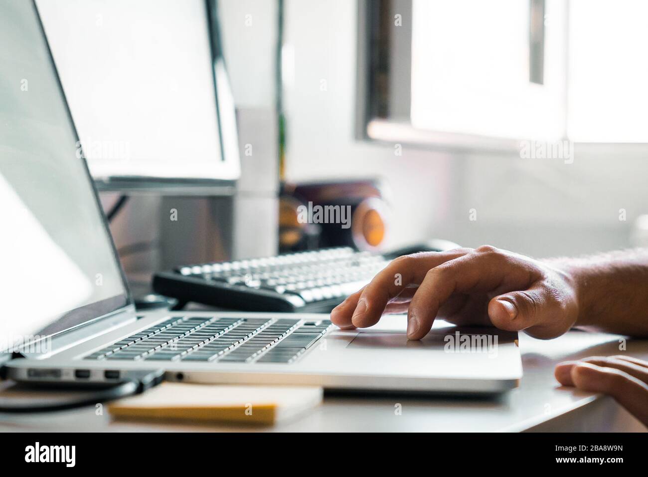 Person working with the computer from home at their desk Stock Photo