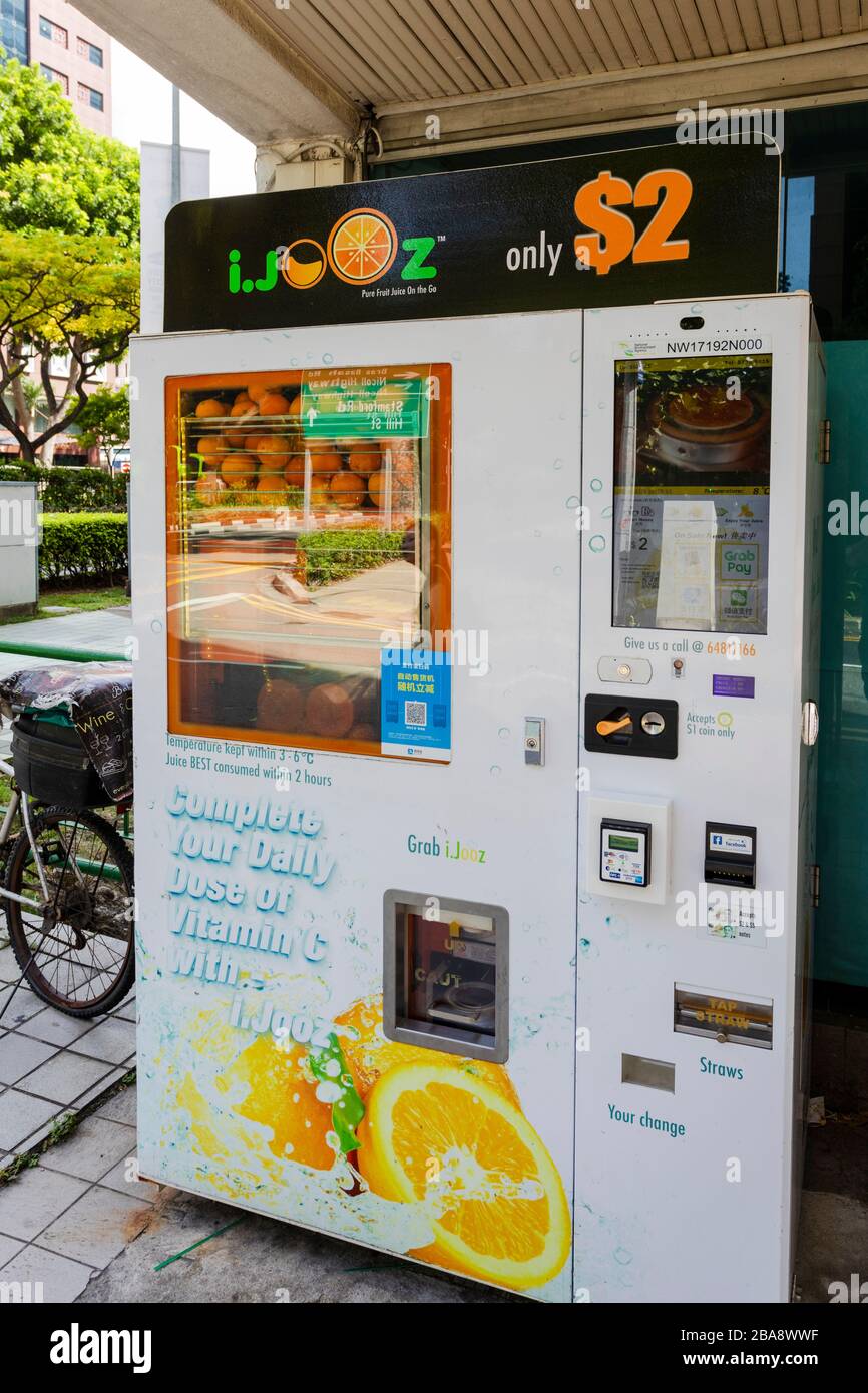 Freshly squeezed orange juice vending machine in Singapore Stock Photo -  Alamy