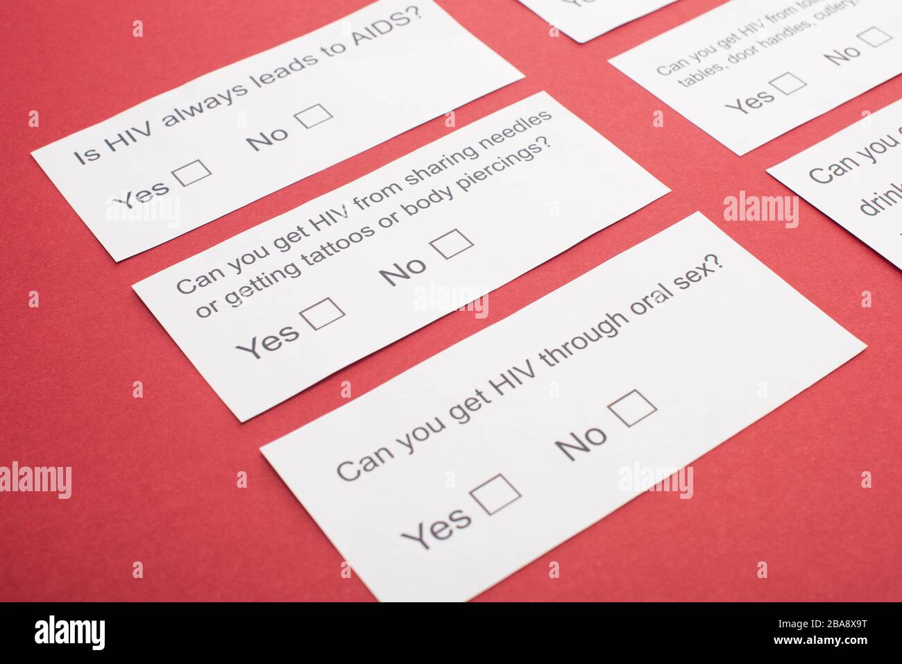 paper cards with HIV questionnaire on red background Stock Photo - Alamy