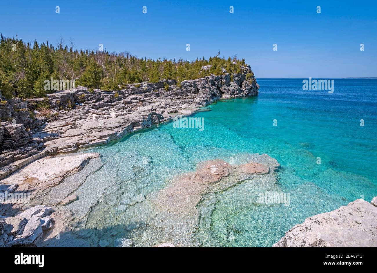 Clear Waters in a Gray Cliffed Cove at Indian Cove in Bruce Peninsula National Park in Ontario Stock Photo